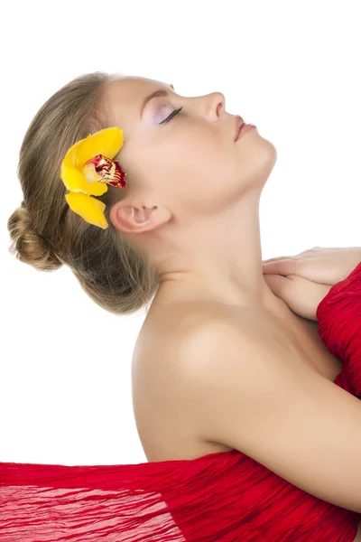 Schönes Mädchen mit einer gelben Orchidee — Stockfoto