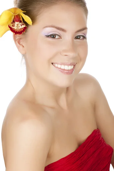 Beautiful girl in red with a yellow orchid — Stock Photo, Image