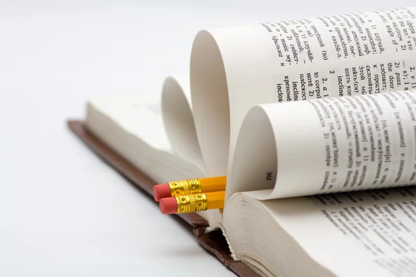 Pencils in book — Stock Photo, Image