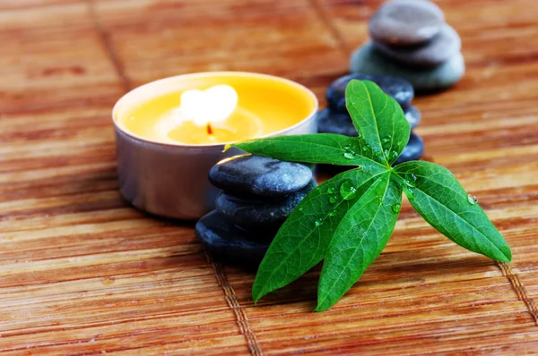 Spa stones with leaf and candle — Stock Photo, Image