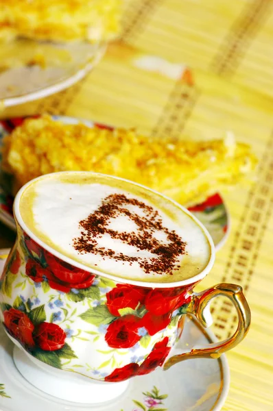 Cappuchino, with chocolate heart and cake — Stock Photo, Image