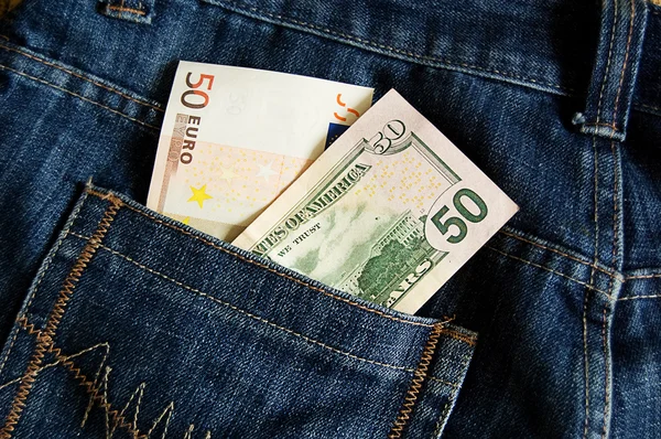 Billetes en euros y dólares en el bolsillo —  Fotos de Stock