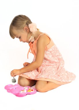 Beautiful girl paints the nails clipart