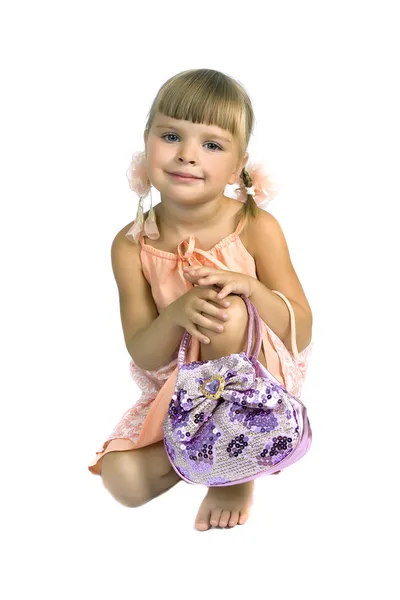 Cute little girl in a summer dress with a bag — Stock Photo, Image