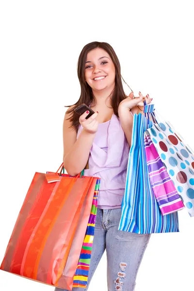 Chica sosteniendo bolsas de compras y teléfono celular — Foto de Stock