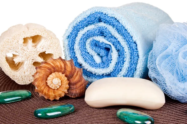 Soap, towel, loofah on mat — Stock Photo, Image