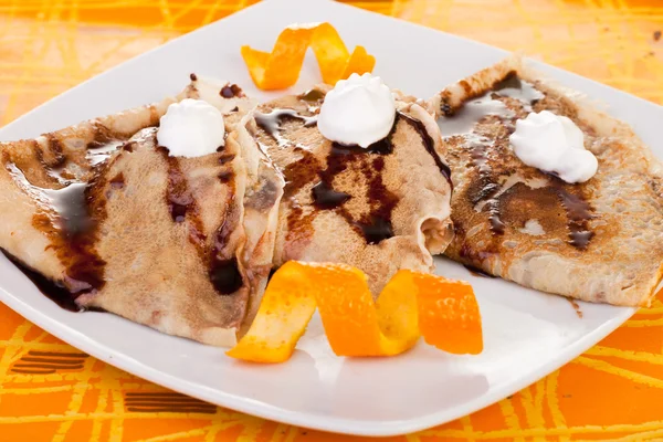Pancakes decorated with orange — Stock Photo, Image