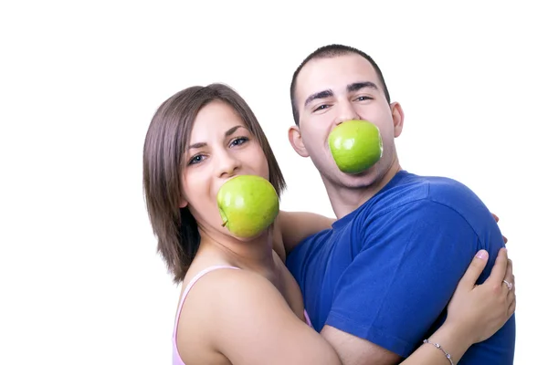 Pareja divertida con manzanas en la boca — Foto de Stock