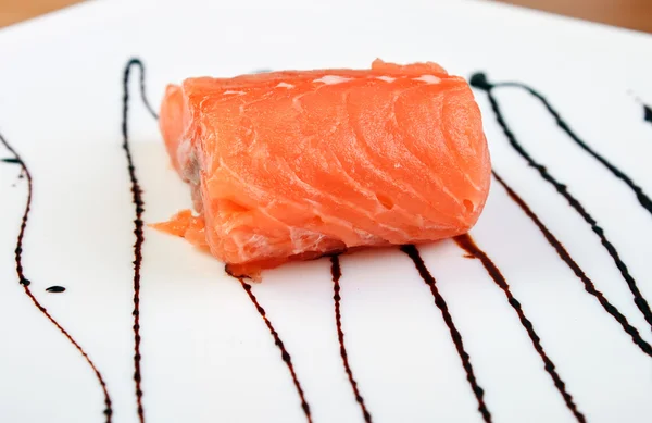 Salmon on plate with soy sauce — Stock Photo, Image