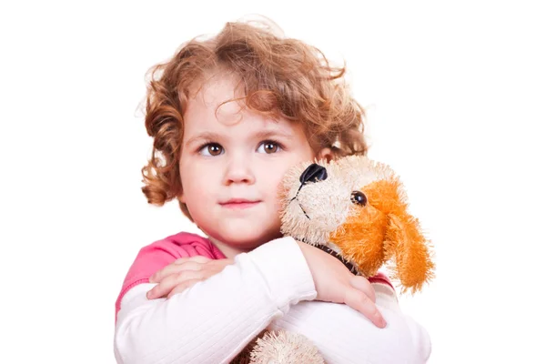 Pretty girl hugging toy dog — Stock Photo, Image
