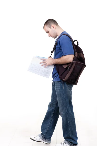 Young male student walking to school and studying — Stock Photo, Image