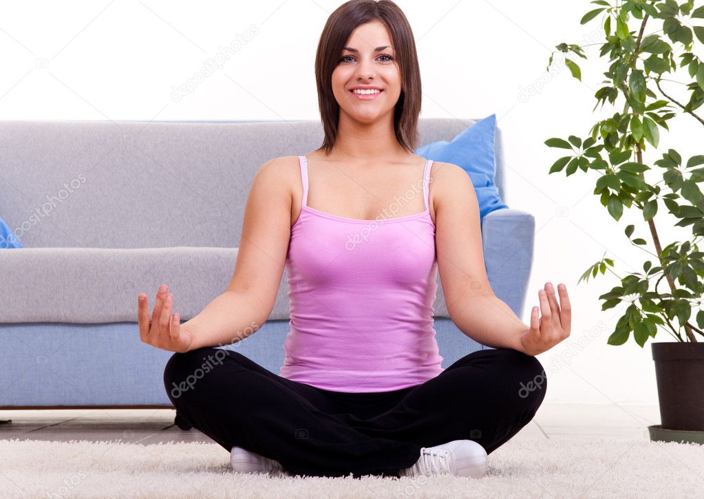 Woman meditating in her apartment