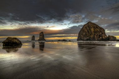 Sunrise at Haystack Rock on Cannon Beach clipart