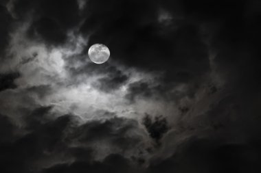 Spooky full moon and eerie white clouds clipart