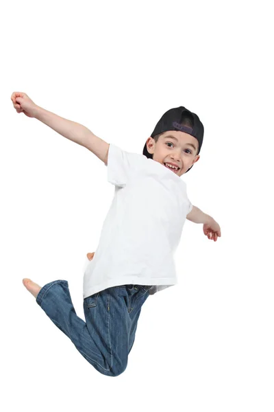 Menino pulando em fundo branco isolado — Fotografia de Stock