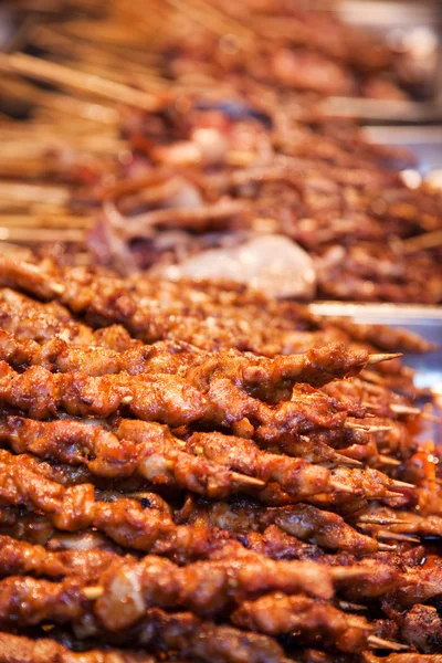 Stock image Roasted meat on wood sticks