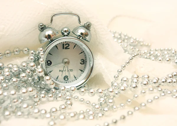 Hours and beads on a white background — Stock Photo, Image
