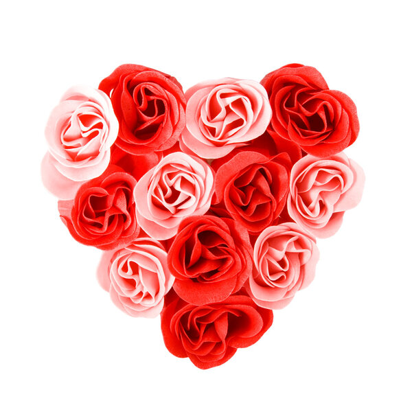 Heart of red and pink roses isolated over white