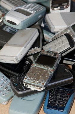 Close-up on an old mobile phones stack clipart