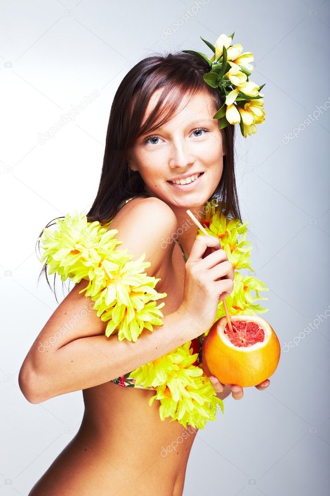 Beautiful girl drinking grapefruit