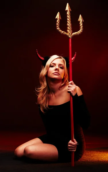 Beautiful devil with trident on black Stock Photo