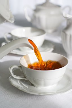 Pouring fresh tea. clipart