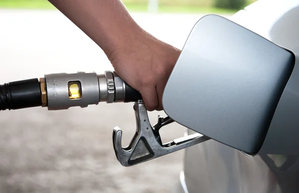 Hand refilling the car with a gas pump — Stock Photo, Image