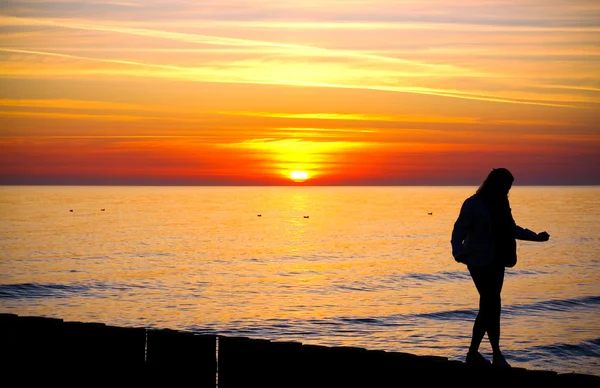 Silhouette of a woman at sunset — Stock Photo, Image
