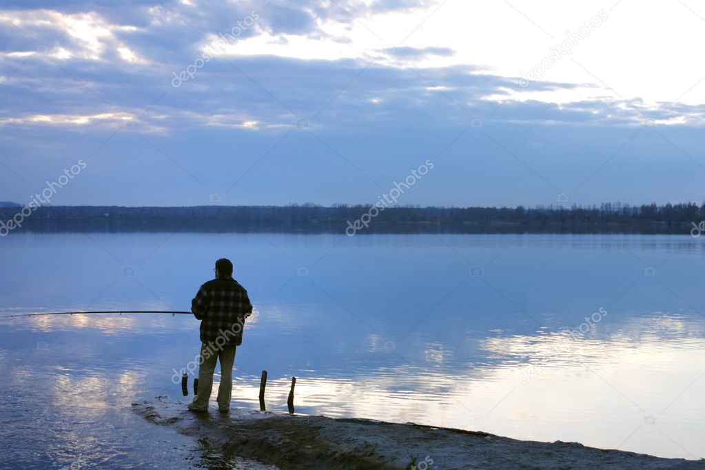 Silhouette of a man fishing in a sunset
