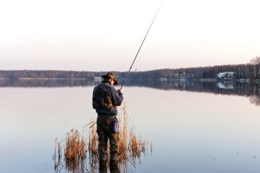 Fishing in a lake clipart