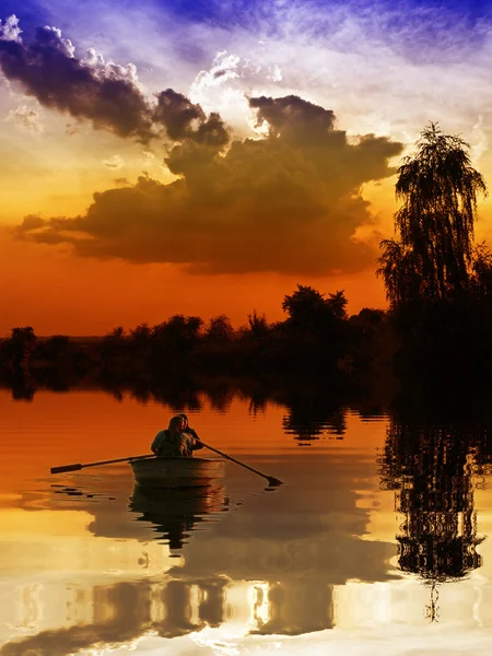 Båt mot en vacker solnedgång — Stockfoto