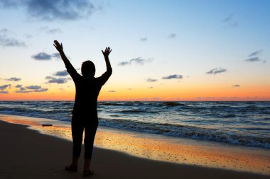 Woman doing yoga at sunset clipart