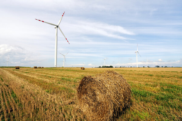 Straw bales and wind turbines farm