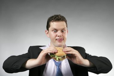 Businessman ready to eat his lunch clipart