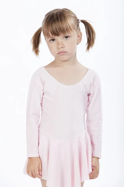 Грустная маленькая девочка с косичками — стоковое фото