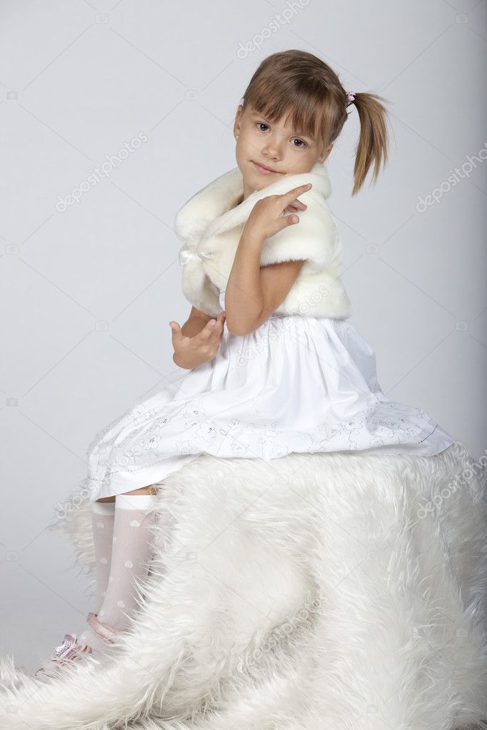 Portrait of a lovely little girl in winter setup, studio image