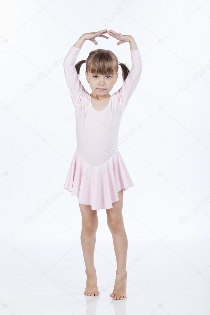 Little ballerina with hands up in the air