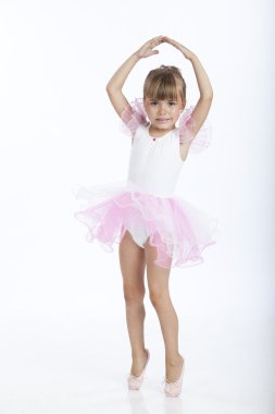 5 years old ballerina trying a new ballet position clipart