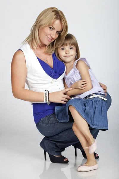 Beautiful young mother and her little daughter smiling — Stock Photo, Image