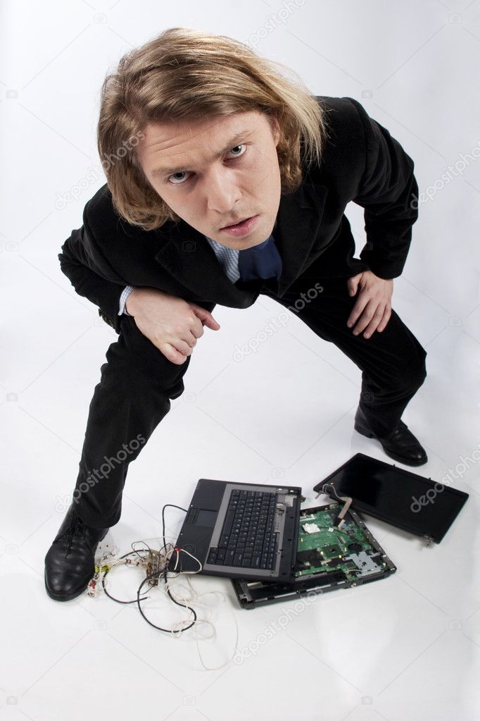 Funny portrait of a businessman with broken laptop
