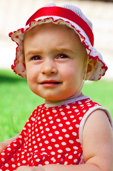 Happy little girl on a lawn — Stock Photo, Image