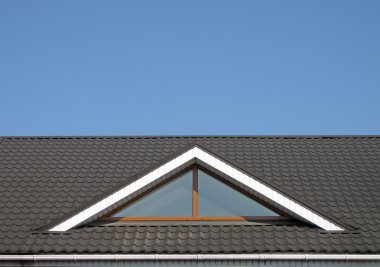 Brown tile roof construction, blue sky clipart