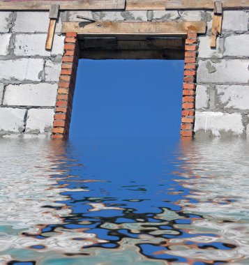 White brick wall iin water, window, blue sky. clipart