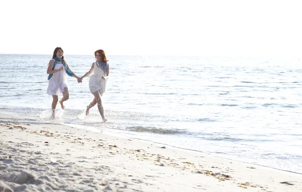 해변에서 실행 하는 두 아름 다운 여자. — 스톡 사진