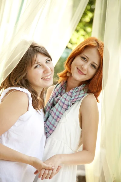 Portrait of two beautiful girls at outdoor. — Stock Photo, Image
