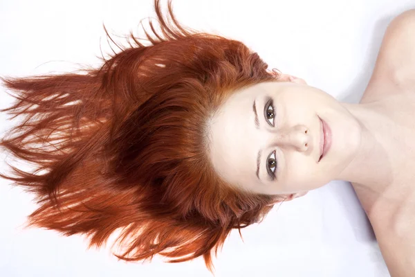 Close-up beautiful fresh young lady in studio shot with red hair — Stock Photo, Image