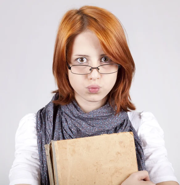 Jovem duvidando menina da moda em óculos com livro velho — Fotografia de Stock