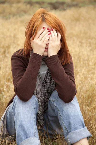 Самотня сумна руда дівчина на полі — стокове фото
