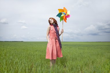 Girl at green wheat field with wind turbine clipart