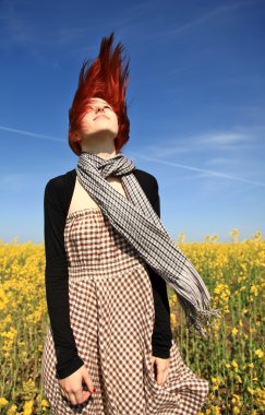 Young girl at rape field. clipart